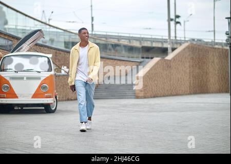 Man walking down street looking to side Stock Photo