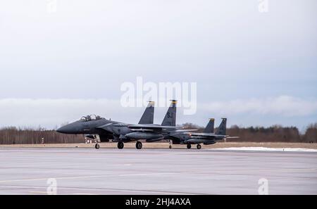 Two F-15E Strike Eagles, assigned to the 4th Fighter Wing from Seymour Johnson Air Force Base in N.C., are parked at Ämari Air Base, Estonia, Jan. 26, 2022.   The F-15E Strike Eagles, along with Belgian F-16s, are deployed to Ämari Air Base in support of a NATO enhanced Air Policing mission. NATO’s enhanced Air Policing missions demonstrate solidarity, collective resolve and its ability to adapt and scale its defensive missions and deterrence posture in response to the evolving security situation facing the alliance. (U.S. Air Force photo by Staff Sgt. Megan Beatty) Stock Photo