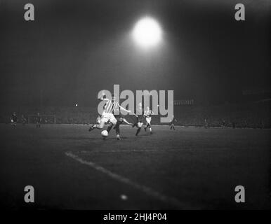 West Bromwich Albion 6- 5 Red Army, friendly european football match played under floodlights at The Hawthorns, Tuesday 29th October 1957. Red Army aka PFC CSKA Moscow aka PFC Central Sport Club of the Army, Moscow aka CSKA Moscow. Pictured, Russian left back Krutikov wraps his leg round Albion inside left Derek Kevan and brings him down. It brought Albion their first penalty. Stock Photo
