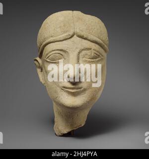 Limestone head of a beardless male with a fillet first half of the 6th century B.C. Cypriot Wearing close-fitting wig or cap.. Limestone head of a beardless male with a fillet. Cypriot. first half of the 6th century B.C.. Limestone. Archaic. Stone Sculpture Stock Photo