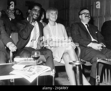 Sammy Davis Jnr with his wife, actress May Britt, watching an extract of his new film 'Sergeants Three' at The Mayfar Hotel, London.3rd October 1961. Stock Photo