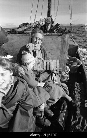 The last twenty three residents of Inishark Island (sometimes called Shark Island), off the coast of County Galway, Ireland, are pictured evacuating the Island. The residents have lost their battle with the winds. After being cut off from the mainland for weeks, sometimes months on end, the six families have left for the mainland to live in houses provided by the Irish government. 21st October 1960. Stock Photo