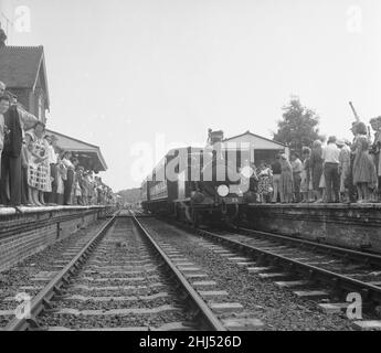 Crowds on the platform at Horsted Keynes station await the arrival of the London, Brighton & South Coast Railway locomotive  No. 55 'Stepney', a Bluebell Line train from Sheffield Park.  8th August 1960. Stock Photo