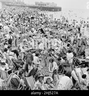 A busy scene on the seafront at Margate, Kent with holidaymakers packing the beach during the Summer holidays. 3rd August 1961. Stock Photo