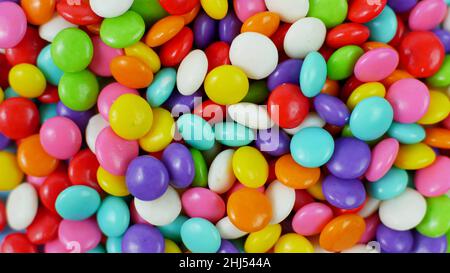 colorful sweet candy balls on blue pastel background. trendy color for wallpaper or background. Stock Photo