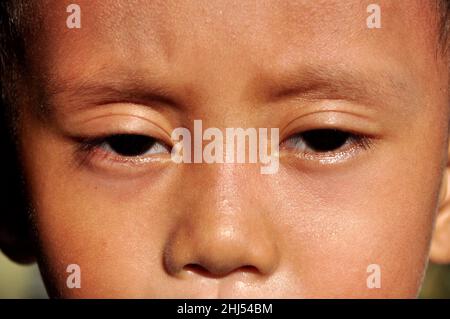 Close-up of an Indonesian boy with eyes looking ahead Stock Photo