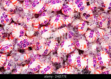 A display of individually wrapped red and white Brach's Star Brites Peppermint Starlight Mints Hard Candy Stock Photo