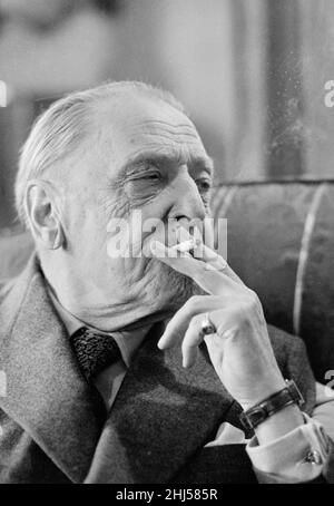 British writer William Somerset Maugham photographed smoking a cigarette at his home. April 1959. Stock Photo