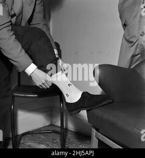 Singer and actor Tommy Steele showing off his Rock 'n' Roll socks. 29th December 1956. Stock Photo