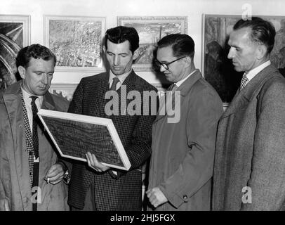 Three German miners admire the work of Norman Cornish, the Durham miner artist, at his exhibition in the Stone Gallery, Newcastle. The Germans, on a fraternal visit to the North East, are Johannes Schurer, Kurt Bretschnieder and Hans Papritz. Circa 1959. Stock Photo