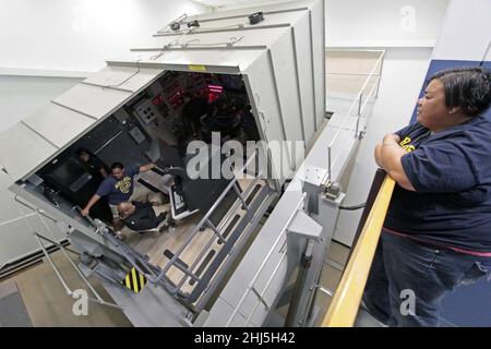 Students from Mira Mesa High School Air Force Junior Reserve Officer Training Corps (JROTC) experience a simulated emergency blow in the Ship's Control Station trainer. Stock Photo