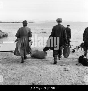 The last twenty three residents of Inishark Island (sometimes called Shark Island), off the coast of County Galway, Ireland, are pictured evacuating the Island. The residents have lost their battle with the winds. After being cut off from the mainland for weeks, sometimes months on end, the six families have left for the mainland to live in houses provided by the Irish government. 21st October 1960. Stock Photo