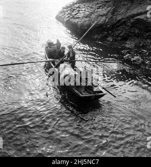 The last twenty three residents of Inishark Island (sometimes called Shark Island), off the coast of County Galway, Ireland, are pictured evacuating the Island. The residents have lost their battle with the winds. After being cut off from the mainland for weeks, sometimes months on end, the six families have left for the mainland to live in houses provided by the Irish government. 21st October 1960. Stock Photo