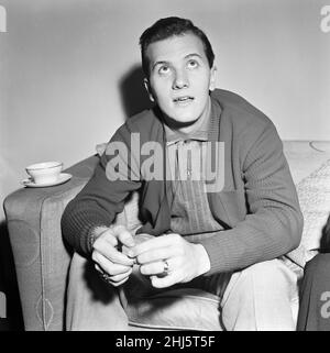 American singer Pat Boone in the UK for a series of television and variety engagements. 22 year old Pat is a father of three children. He has sold 14,000,000 records in two years. He is still studying for his BA and works about two weeks a month singing and two weeks at college. 25th December 1956. Stock Photo