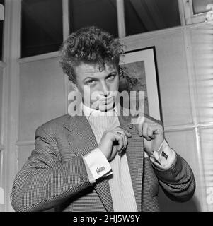 Singer and actor Tommy Steele showing of this Rock 'n' Roll cufflinks. 29th December 1956. Stock Photo