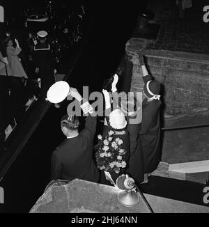 Queen Elizabeth II and Prince Philip, Duke of Edinburgh ending their state visit to Denmark. Saying their goodbyes at Helsingor. Queen Elizabeth II and Prince Philip are on board the barge waving farewell to the Danish Royal Family - King Frederik, Queen Ingrid,  Princess Benedikte, Princess Anne Marie and Princess Margrethe. 25th May 1957. Stock Photo