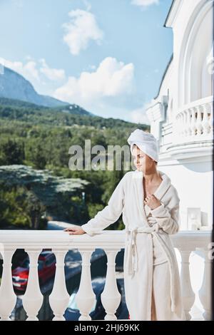 woman posing against the backdrop of mountains on the balcony architecture unaltered Stock Photo