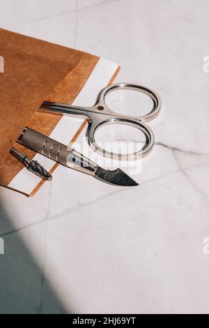 Clean manicure instruments. Manicure set in paper heat dry bag for sterilization. Sterilization of instruments healthcare concept Stock Photo