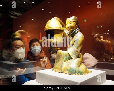 BEIJING, CHINA - JANUARY 26, 2022 - Visitors look at 'Changxin Palace Lanterns (Han Dynasty)' at the 'Why China' exhibition at the Palace Museum wenhu Stock Photo