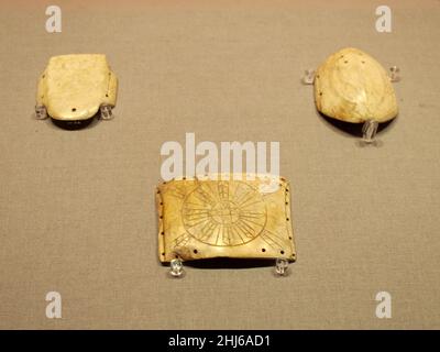 BEIJING, CHINA - JANUARY 26, 2022 - Jade plates with octagonal star patterns and jade Turtles (Neolithic Lingjiatan Culture) are on display at the Exh Stock Photo