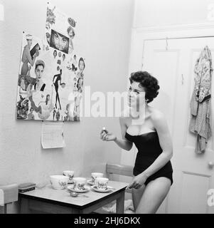 Valerie Gaunt, British actress, will be starring in her first film, The Curse of Frankenstein as Justine, Pictured Wednesday 3rd April 1957. Our Picture Shows ... Valerie consults a calorie chart, to see if she can have a cube of sugar in her cup of tea. Stock Photo