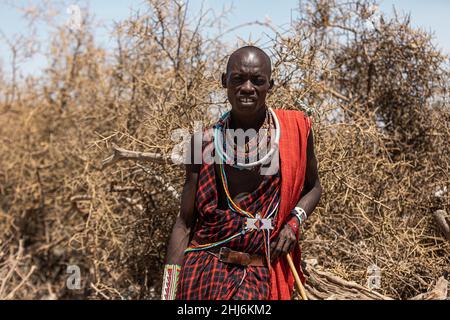 AMBOSELI NATIONAL PARK - SEPTEMBER 17, 2018: Maasai warrior in traditional dress with accessories Stock Photo