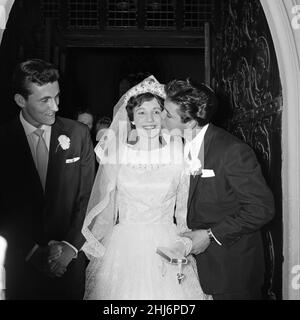 The wedding of Miss Ann Findley and Mr Bruce Welch, Cliff Richard is the best man, pictured kissing the bride. London, August 1959. Stock Photo