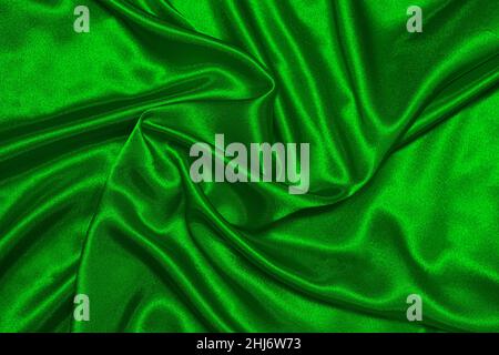 Texture of crumpled green satin fabric, beautiful pattern, top view. Stock Photo