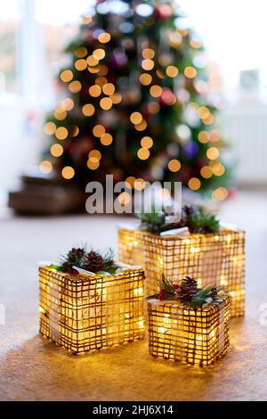 Illuminated decorations in front of Christmas Tree Stock Photo