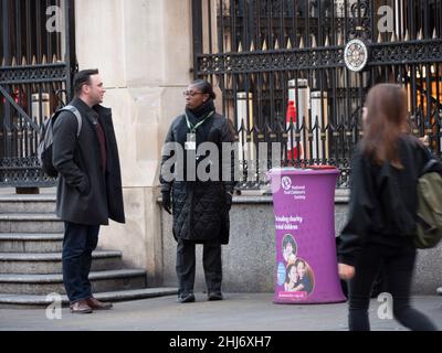 National deaf children's society, charity collector commonly known as chuggers or fund raisers, working outside Liverpool Street Station Stock Photo