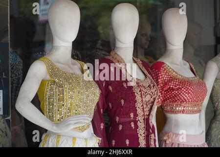 Mannequins dressed in latest fashion in front of retail clothes shop. Fashion and Retail Shopping concept. Mannequin Of Female Girls Wearing Colorful Stock Photo