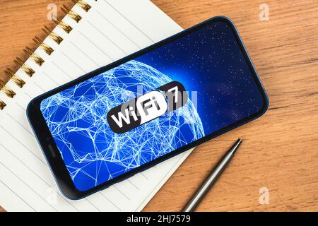 Wi-Fi 7 generation background, icon close-up. Smartphone supporting new Wi-Fi technology for communication, business Stock Photo