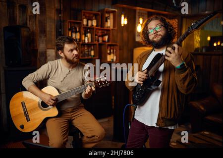 Music tutor playing melody on electric guitar Stock Photo