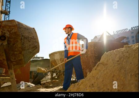 Male worker making concrete at construction site Stock Photo