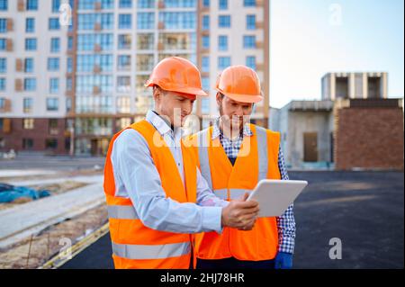 Worker reporting to contractor at construction site Stock Photo