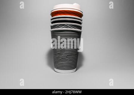 Disposable paper cups for coffee on a gray background. Stock Photo