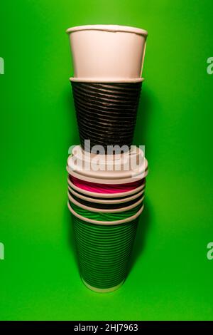 Disposable paper cups for coffee on a green background. Stock Photo