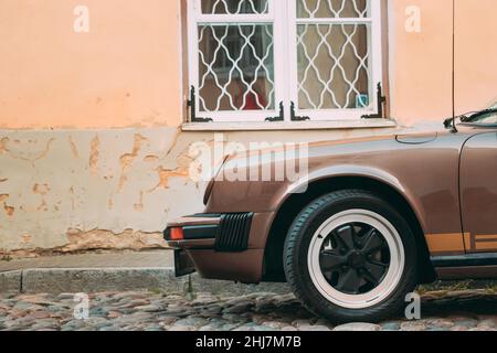 Close View Of Porsche 930 Car Parked In Old Narrow Street. Stock Photo