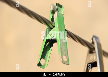 clothes pin hanging on wire. Stock Photo