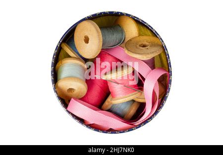 Sewing supplies in a round box. Spool of thread. Isolate on a white background. Stock Photo