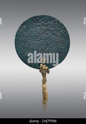 Mycenaean pottery - Bronze mirror with ivory handle, 1500 - 1350 BC, Mycenaean cemetery of Asine. Nafplion Archaeological Museum.  Against grey backgr Stock Photo