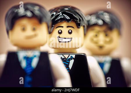 Portrait of a happy businessman in a crowd. Illustrative editorial. January 02, 2022 Stock Photo