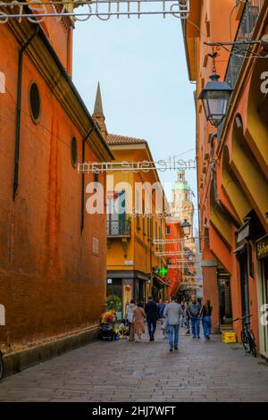 Bologna, Italy: Via Clavature street Quadrilatero, tourists walking across the song lights across buildings and sky Stock Photo