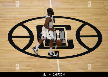 Brooklyn Nets guard James Harden (13) dribbles the ball over the LA Clippers logo during an NBA basketball game, Monday, Dec. 27, 2021, in Los Angeles Stock Photo