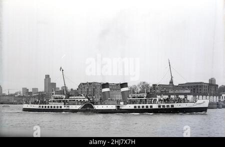 1978, historical, an old paddle steamer, Waverley, going along the river Thames, London, England, UK. She had left Glasgow to come down south to cruise the Thames and the South Coast of England. Built on the Clyde by LNER for the route up Loch Goil and Loch Long in the Highlands, Scotland, 1947 saw her maiden voyage. The last seagoing paddle steamer in the world, In 1974 she was gifted to the Paddle Steamer Preservation Society to start a new life as a tourist attraction. She was named after Scotish writer Sir Walter Sottt's first novel published in 1814. Stock Photo