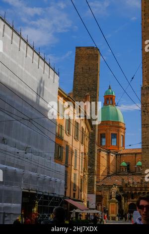 Bologna, Italy: Torre Asinelli, Two towers in old town of the city across the sky and the dome of Complesso di Santo Stefano / Basilica di Santo Stef Stock Photo