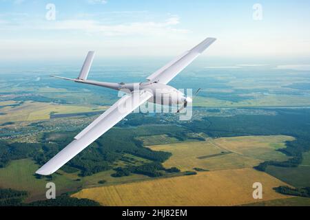 Unmanned military drone on patrol air territory at low altitude Stock Photo