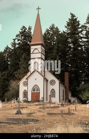 A vertical shot of a church building in Strasburg with a clock on its ...