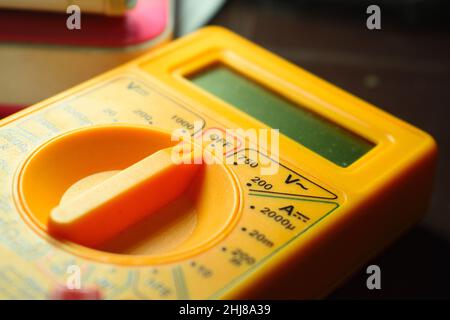 A small digital micrometer. A multimeter is an electronic measuring instrument that combines several measurement functions in one unit. Stock Photo