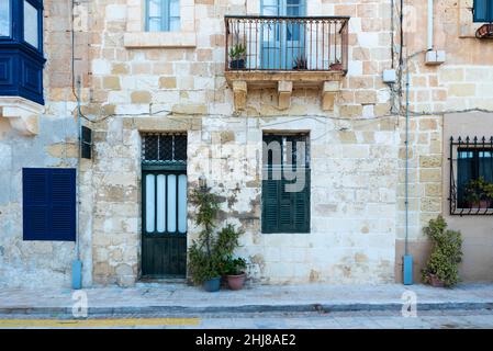 Valletta, Malta - 01 06 2022: Traditional facade of residential houses in Mediterranean style Stock Photo